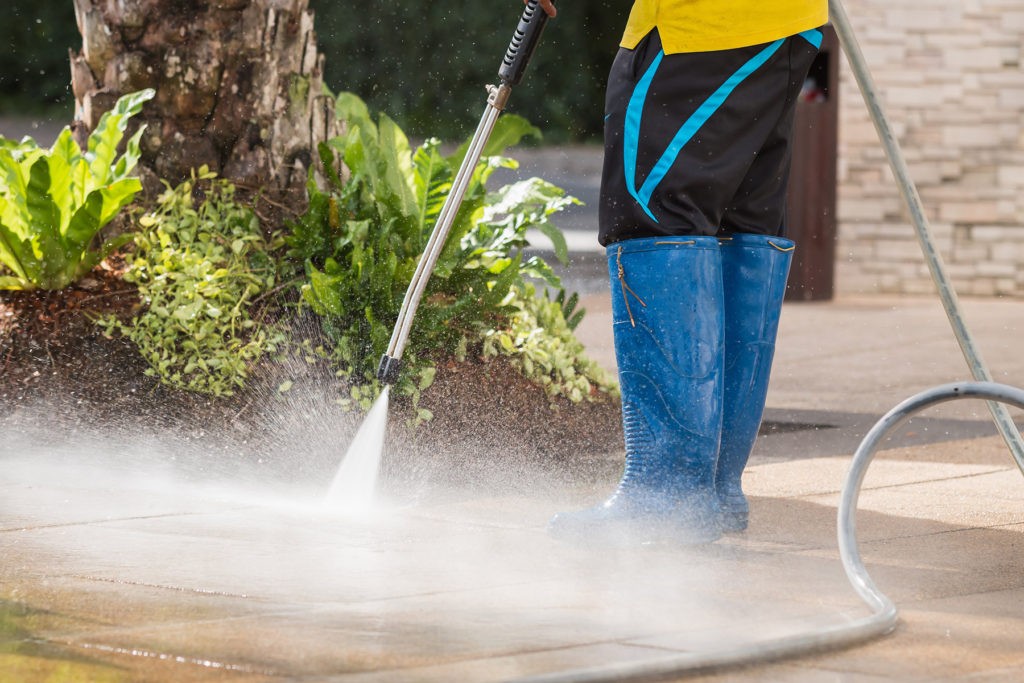 cleaning pavement with pressurized water with the help of a specialized equipment